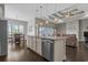 Open-concept kitchen island with a sink and a dishwasher and view of the living and dining area at 713 Garland Ct., Myrtle Beach, SC 29588