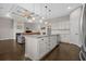 Open kitchen featuring granite counters, white cabinets, stainless appliances, and a view to the living room at 713 Garland Ct., Myrtle Beach, SC 29588