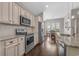 Well-lit kitchen with granite countertops, stainless steel appliances, and white cabinets at 713 Garland Ct., Myrtle Beach, SC 29588