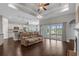 Open-concept living room boasts tray ceilings, wood floors, and access to the kitchen and backyard at 713 Garland Ct., Myrtle Beach, SC 29588