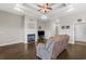 Comfortable living room showcasing a fireplace, a ceiling fan, and dark wood flooring at 713 Garland Ct., Myrtle Beach, SC 29588