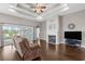Bright living room with sliding glass doors, a fireplace, and dark wood flooring at 713 Garland Ct., Myrtle Beach, SC 29588