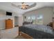 Main bedroom with trey ceiling, large windows, TV, and carpeted floors at 713 Garland Ct., Myrtle Beach, SC 29588