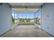 Spacious screened-in patio with view of the backyard, ceiling fan, and blue siding at 713 Garland Ct., Myrtle Beach, SC 29588
