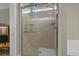 Elegant glass shower with marble tile and a rainfall shower head in the main bathroom at 713 Garland Ct., Myrtle Beach, SC 29588