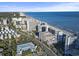 Panoramic aerial view capturing beachfront homes, high-rise buildings, and the vastness of the ocean at 7200 N Ocean Blvd. # 431, Myrtle Beach, SC 29572