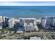 Expansive aerial view showcasing a beachfront hotel with ocean views, a parking garage, and a lively street scene at 7200 N Ocean Blvd. # 431, Myrtle Beach, SC 29572