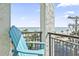 Balcony view with a comfortable Adirondack chair and a stunning view of the beach at 7200 N Ocean Blvd. # 431, Myrtle Beach, SC 29572
