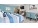 Bright bedroom featuring two beds with striped bedding, a dresser, and a wall-mounted TV at 7200 N Ocean Blvd. # 431, Myrtle Beach, SC 29572