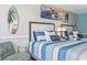 Inviting bedroom showcasing two beds, beachy wall art, and a cozy chair, perfect for relaxation at 7200 N Ocean Blvd. # 431, Myrtle Beach, SC 29572