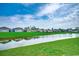 Beautiful exterior community view showcasing the pond and manicured lawn at 777 Woodland Farms Circle, Aynor, SC 29511
