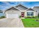 Charming single-story home with a well-maintained lawn, attached garage, and inviting front entrance at 777 Woodland Farms Circle, Aynor, SC 29511