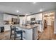 Bright kitchen with large island, granite countertops, stainless steel appliances, and white cabinets at 777 Woodland Farms Circle, Aynor, SC 29511