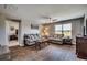 Comfortable living room with hardwood floors, cozy sofas, and a large window for natural light at 777 Woodland Farms Circle, Aynor, SC 29511