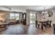 Open-concept living room and dining area with modern decor, wood floors, and plenty of natural light at 777 Woodland Farms Circle, Aynor, SC 29511