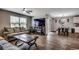 Comfortable living room with hardwood floors, large windows, and a cozy fireplace at 777 Woodland Farms Circle, Aynor, SC 29511