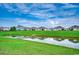 Scenic pond surrounded by lush greenery, offering a tranquil view of the community at 777 Woodland Farms Circle, Aynor, SC 29511