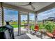 Relaxing screened porch with comfortable seating and a view of the backyard and pond at 777 Woodland Farms Circle, Aynor, SC 29511
