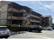 A view of the condo building's exterior with a parking lot and neatly trimmed hedges at 9501 Shore Dr. # D-237, Myrtle Beach, SC 29572