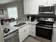 Well-appointed kitchen featuring stainless steel appliances and elegant white cabinetry at 9501 Shore Dr. # D-237, Myrtle Beach, SC 29572