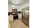 Modern kitchen with stainless steel appliances, light cabinets, and stone countertops at 9501 Shore Dr. # D-237, Myrtle Beach, SC 29572