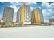Attractive condo building with multiple floors and balcony views, set near a sandy beach at 9550 Shore Dr. # 531, Myrtle Beach, SC 29572