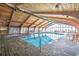 Indoor pool area with a vaulted wood ceiling, brick-look flooring, and lots of light at 9550 Shore Dr. # 531, Myrtle Beach, SC 29572