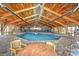 Indoor pool with vaulted wood ceilings and brick-look flooring with tables and chairs at 9550 Shore Dr. # 531, Myrtle Beach, SC 29572