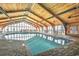 Bright indoor pool area featuring tall ceilings with wood beams, tables, and chairs at 9550 Shore Dr. # 531, Myrtle Beach, SC 29572