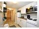 Condo kitchenette including white appliances, cabinetry, and tile floor at 9550 Shore Dr. # 531, Myrtle Beach, SC 29572