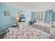 Bright bedroom with two beds, balcony access, and ocean-themed decor for a cozy coastal retreat at 9820 Queensway Blvd. # 704, Myrtle Beach, SC 29572