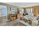 This bedroom features wood floors, a tropical bedspread, and a TV with dresser at 9820 Queensway Blvd. # 704, Myrtle Beach, SC 29572