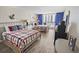 Cozy bedroom featuring two beds with metal frames, wood floors and a waterfront balcony at 9820 Queensway Blvd. # 704, Myrtle Beach, SC 29572