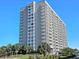 Stunning high-rise condo building with balconies and beautiful landscaping at 9820 Queensway Blvd. # 704, Myrtle Beach, SC 29572