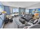 Comfortable living room featuring modern decor, a leather sofa, and balcony access at 9820 Queensway Blvd. # 704, Myrtle Beach, SC 29572