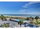 Scenic view of the pool, beach, and ocean, surrounded by lush palm trees and parking lot at 9820 Queensway Blvd. # 704, Myrtle Beach, SC 29572