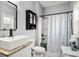 Well-lit bathroom featuring granite counters, modern fixtures and a shower behind a patterned curtain at 1017 Gallinule Dr., Conway, SC 29526