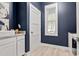 Stylish powder room with modern vanity, elegant decor, and navy walls, creating a chic space at 1017 Gallinule Dr., Conway, SC 29526
