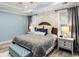 Comfortable bedroom with stylish bedding, light blue walls and ceiling, and plenty of natural light at 1017 Gallinule Dr., Conway, SC 29526