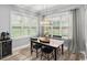 Cozy dining area with a table set for four, bright windows, and modern décor at 1017 Gallinule Dr., Conway, SC 29526