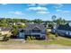 Rear exterior view of a stunning home with a screened-in porch and beautifully landscaped backyard at 1017 Gallinule Dr., Conway, SC 29526