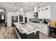 Spacious kitchen with marble countertops, white cabinets, stainless steel appliances, and a large island at 1017 Gallinule Dr., Conway, SC 29526