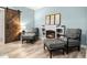 Inviting sitting room featuring cozy chairs with ottomans, fireplace, stylish decor, and barn door entry at 1017 Gallinule Dr., Conway, SC 29526