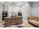 Bright office space with a large wooden desk, chandelier lighting, and a comfortable seating area at 1017 Gallinule Dr., Conway, SC 29526