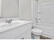 Bright bathroom featuring a white vanity, toilet, and shower-tub combination with white surround at 1043 Sentinel Ct., Little River, SC 29566