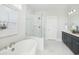 Modern bathroom features a freestanding tub, glass-enclosed shower, double vanity, and elegant marble flooring at 1071 Milford Way, Myrtle Beach, SC 29588