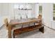Dining room features a rustic table, bench seating, natural textures, decorative lighting and a neutral color scheme at 1071 Milford Way, Myrtle Beach, SC 29588