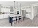 Modern kitchen features white cabinets, stainless steel appliances, an island with seating, and elegant pendant lighting at 1071 Milford Way, Myrtle Beach, SC 29588