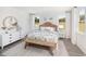 Bright primary bedroom featuring wood flooring, shiplap accent wall, and a cozy decor at 1071 Milford Way, Myrtle Beach, SC 29588