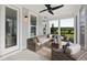 Outdoor patio with wicker furniture, ceiling fan, and screened-in views of the property at 1071 Milford Way, Myrtle Beach, SC 29588